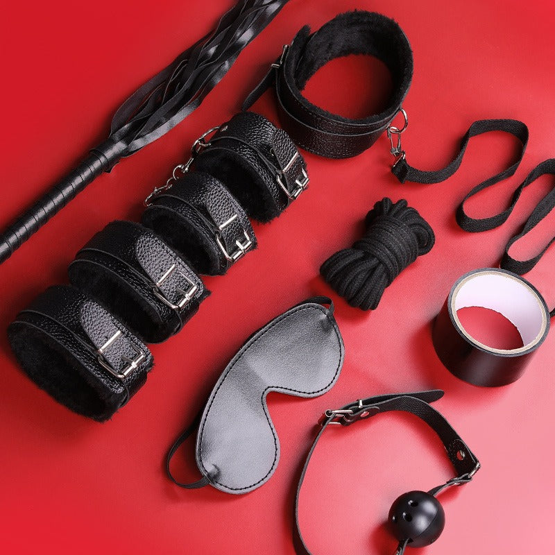Black leather accessory set displayed on red background