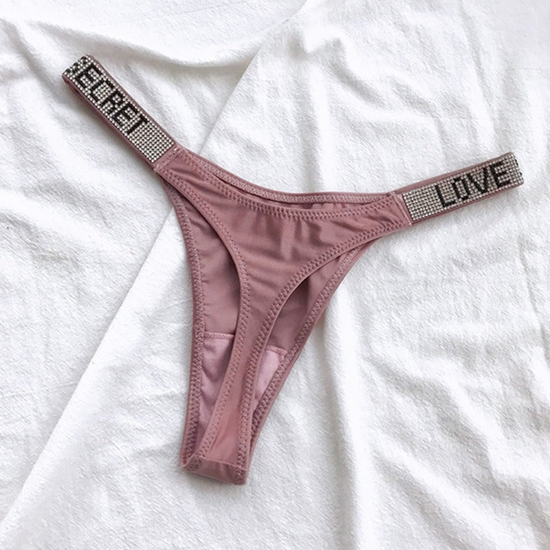 Mauve thong with rhinestone straps featuring the words LOVE and SECRET