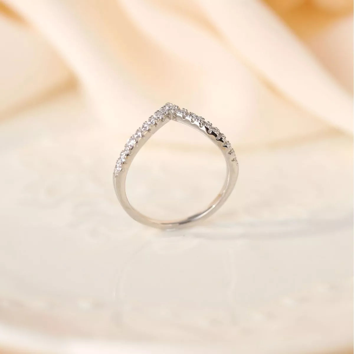 Back view of a V-shaped sterling silver ring with pavé-set diamonds